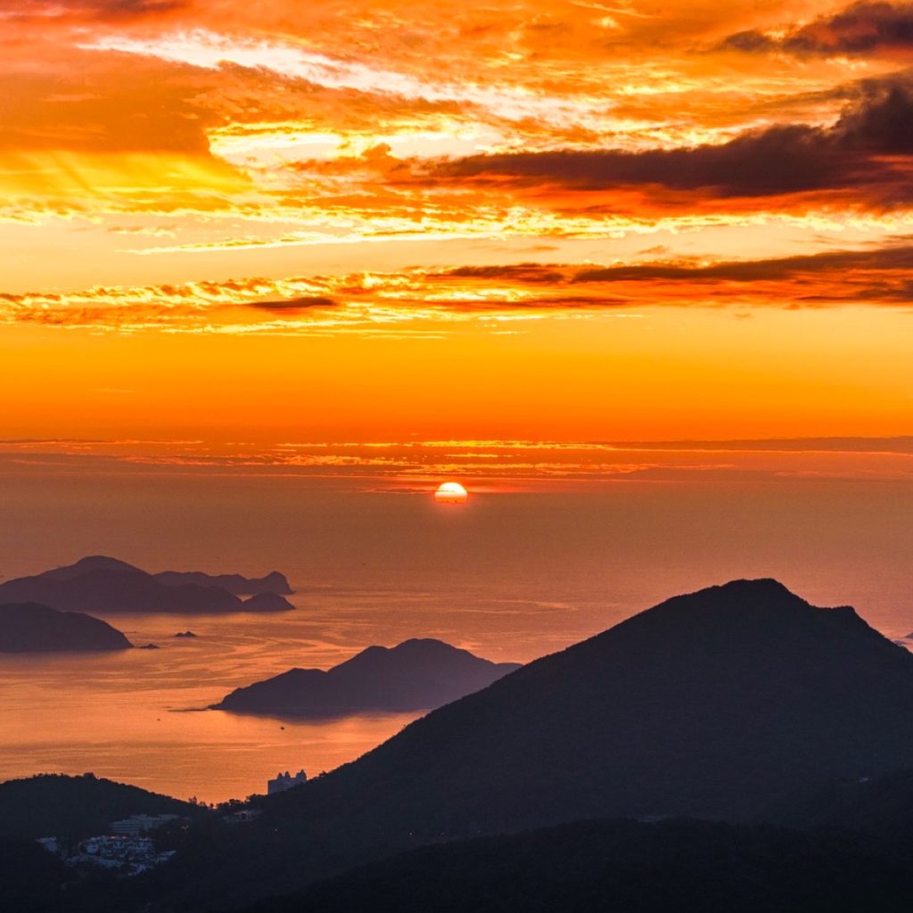 A golden sunset over the Greek sea and islands